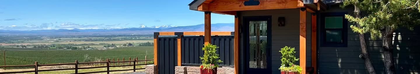 Covered entry of a renovated home with cedar posts, overlooking the Kittitas valley and the Cascades