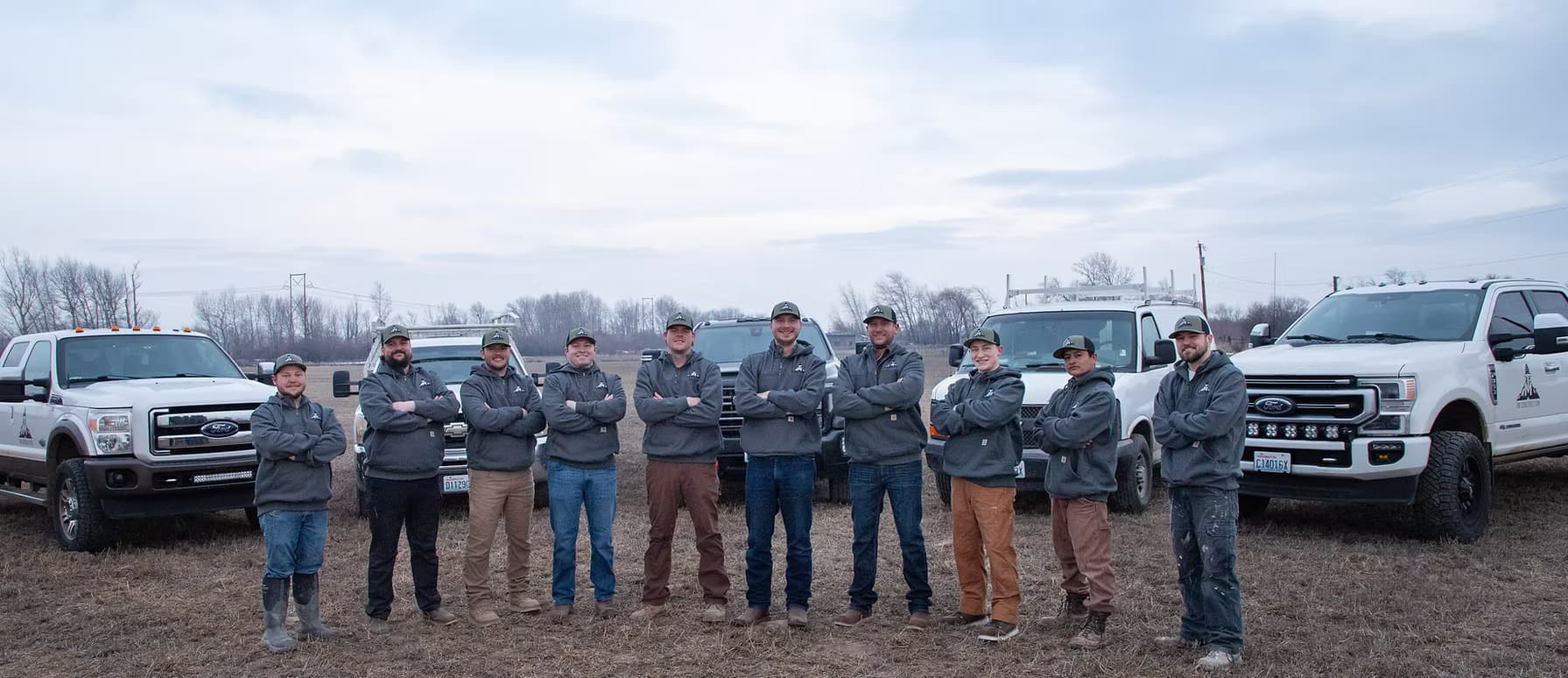 The TM Construction crew standing in front of their trucks in Central Washington